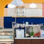 Modern small cafe bar with commercial espresso machine and coffee display case