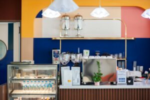 Modern small cafe bar with commercial espresso machine and coffee display case