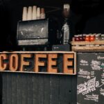 Comparison between a commercial espresso machine and a home espresso machine showing professional cafe equipment versus household coffee equipment.