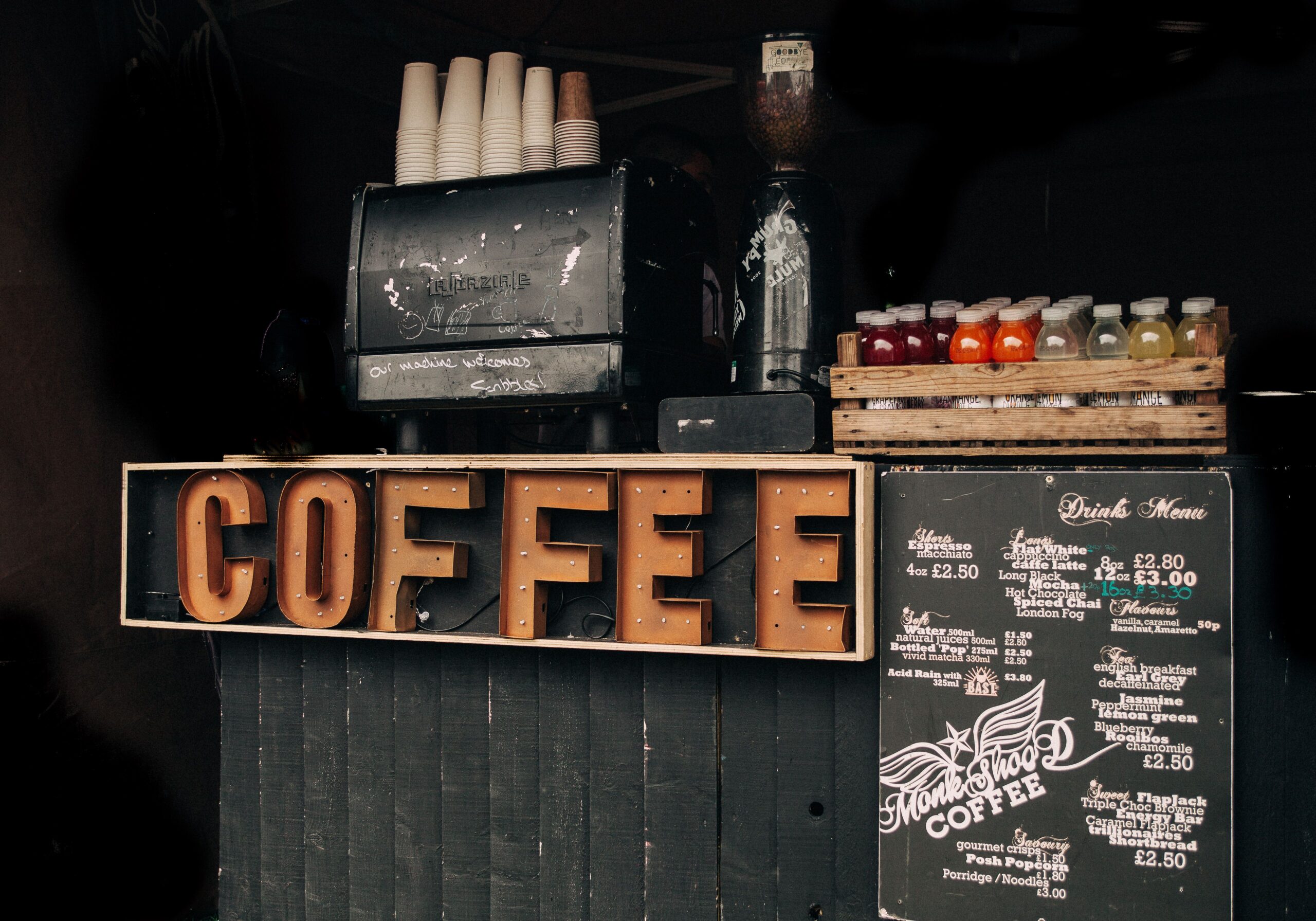 Comparison between a commercial espresso machine and a home espresso machine showing professional cafe equipment versus household coffee equipment.