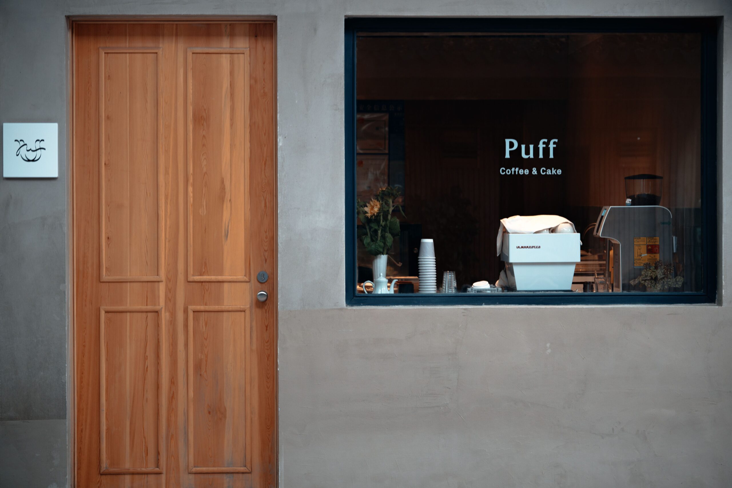 Barista performing routine maintenance on a commercial espresso machine in a coffee shop to ensure consistent coffee quality and reliable performance.