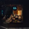 barista calibrating a commercial coffee syrup dispenser in a modern cafe