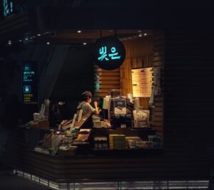 barista calibrating a commercial coffee syrup dispenser in a modern cafe