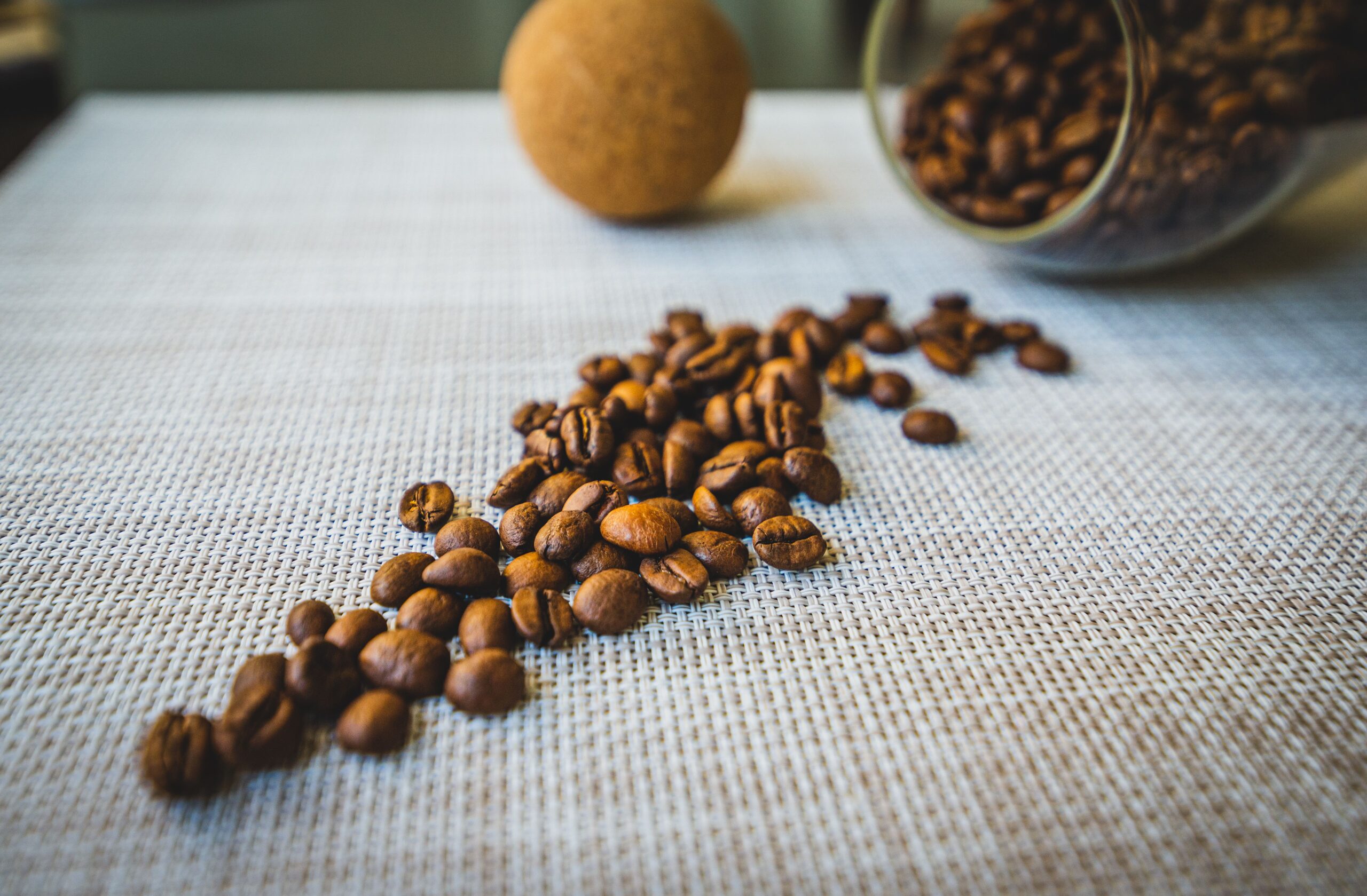 coffee beans being weighed on a digital scale for daily cafe coffee consumption planning