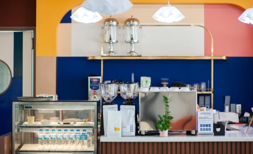 Modern small cafe bar with commercial espresso machine and coffee display case