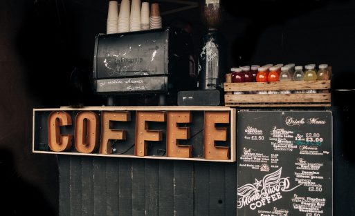 Comparison between a commercial espresso machine and a home espresso machine showing professional cafe equipment versus household coffee equipment.