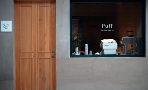 Barista performing routine maintenance on a commercial espresso machine in a coffee shop to ensure consistent coffee quality and reliable performance.