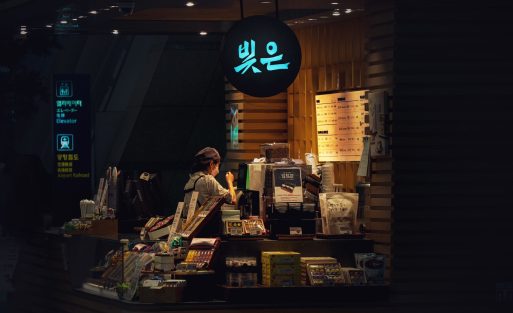 barista calibrating a commercial coffee syrup dispenser in a modern cafe